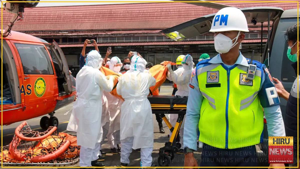 Indonesian rescuers plan to right capsized ship as weather hampers search for 129 missing people